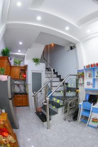 a room with a staircase in a house at SƠN THỊNH Guesthouse in Ho Chi Minh City