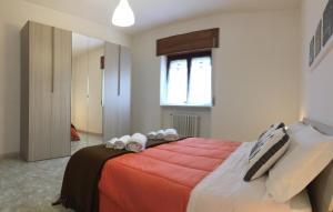 a bedroom with a large bed with towels on it at Parco Adamantina di Fronte al Mare in Diamante