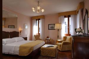 a hotel room with two beds and two lamps at Pensione Accademia - Villa Maravege in Venice