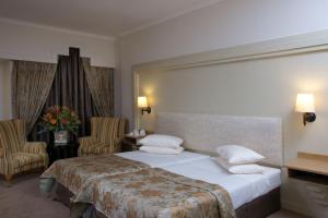 Postel nebo postele na pokoji v ubytování Apollo Hotel