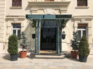 a glass doorway to a building with two potted plants at Grande Albergo Quattro Stagioni in Rieti