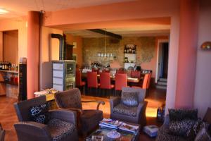 a living room with a kitchen and a dining room at Il Grillo Parlante in Monforte dʼAlba