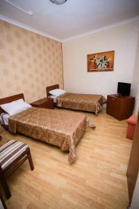 מיטה או מיטות בחדר ב-Guest House Uyut