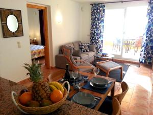 a living room with a table with a bowl of fruit at Apartment Vistamar 2 in Cumbre del Sol