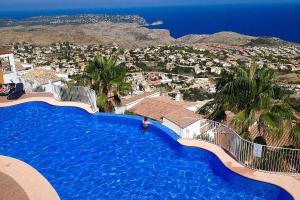 a large swimming pool with a view of a city at Apartment Vistamar 2 in Cumbre del Sol