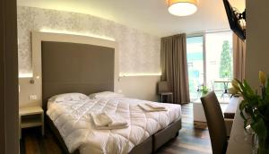 Postel nebo postele na pokoji v ubytování Hotel Gardesana