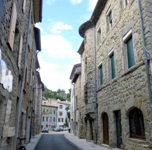 an alley in an old town with stone buildings at le pavillon pierre naturelle in Jaujac