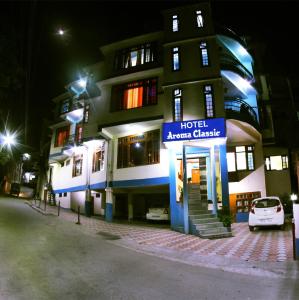 a hotel at night with a car parked in front at Hotel Aroma Classic in Kulu