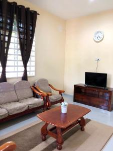 a living room with a couch and a coffee table at Twin Homestay A in Kuala Terengganu