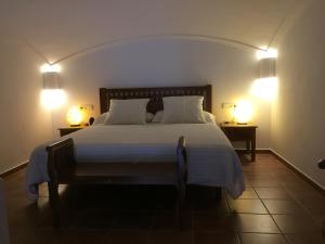 a bedroom with a large bed with two lamps at Apartament Riera in Cadaqués