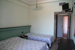 Postel nebo postele na pokoji v ubytování Hotel Palm Beach