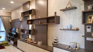 a living room with wooden shelves on the wall at Suite Deluxe at Icon City in Petaling Jaya