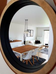 a dining room and living room with a table and chairs at l'Intervalle in Mont-Saint-Guibert