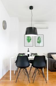 a dining room with a table and two black chairs at Serena Apartment in Podstrana