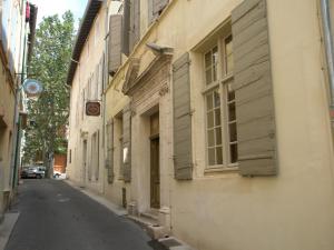 an empty street in an old town with buildings at Hôtel Amphithéâtre in Arles