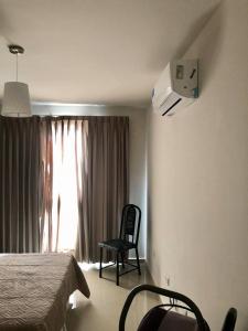 a bedroom with a bed and a chair and a window at Opera Villa Carlos Paz in Villa Carlos Paz +49 photos