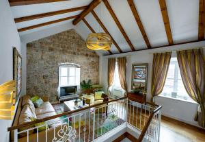 a living room with a stone wall at Dominus Little Palace in Dubrovnik
