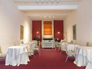 a room with white tables and chairs in it at Hotel Central in Durazno