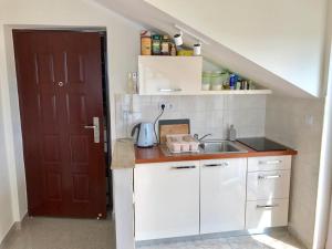 una pequeña cocina con fregadero y puerta en Sun&Sea Apartment, en Vodice