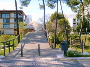 a bridge over a walkway in a city at Apartment Troia Garden in Troia
