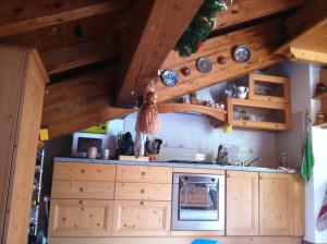 - une cuisine avec des placards en bois et des plafonds en bois dans l'établissement Residence Venezia, 