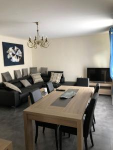 a living room with a table and a couch at Les Charmantes in Cernay