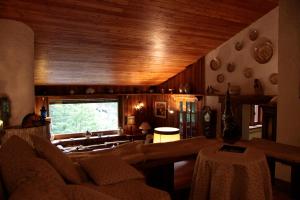 a living room with a couch and a large window at Le Rocce di Scanno B&B di Charme in Scanno