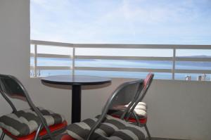 2 stoelen en een tafel in een kamer met uitzicht op de oceaan bij Marica in Rijeka