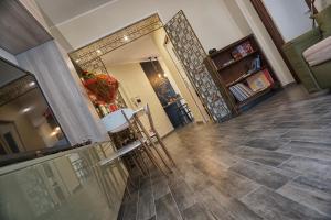 a living room with wood floors and a hallway at Le Note di Elisa in Naples