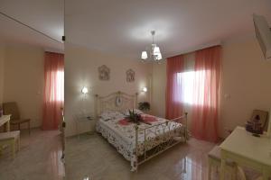 a bedroom with a bed and red curtains at Villa Elena in Katerini