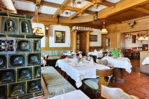 - un restaurant avec des tables et des chaises dans une salle dans l'établissement Gasthof Mühlwinkl, à Staudach-Egerndach