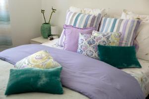 a bed with a bunch of pillows on it at Apartment Tina in Split