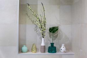 three vases sitting on a shelf with flowers in them at Apartment Tina in Split +40 photos