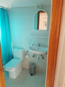 a small bathroom with a toilet and a sink at Niki Apartments in Chrani