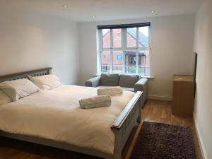 a bedroom with a large bed and a window at Joe Kelly Buildings B in Withernsea
