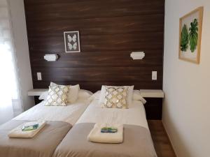 a bedroom with two beds with towels on them at Casa de Campo Cruz de Pedra in Portomarin