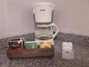 a blender sitting on top of a counter next to a box at Estudio 9 de Julio in San Miguel de Tucumán