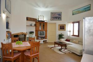 a living room with a table and a couch at La Fonte dell'ulivo 3 in La Maddalena
