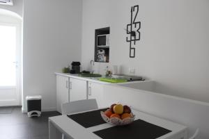 a kitchen with a bowl of fruit on a table at Specula Domus - Ibla in Ragusa