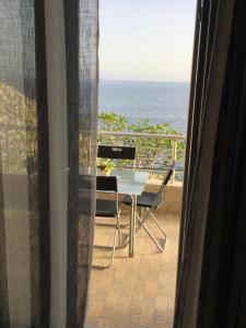 a balcony with a table and chairs and the ocean at Blue Sea Apartments in Qeparo +35 photos