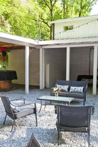 a patio with a couch and a table and chairs at Valle Crucis Farm in Valle Crucis