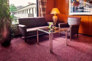 a living room with two chairs and a coffee table at Best Western Hotel Hamburg International in Hamburg