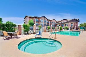
a large swimming pool in front of a large building at Days Inn & Suites by Wyndham Page Lake Powell in Page
