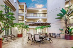 an indoor courtyard with a table and chairs and plants at Days Inn by Wyndham Carlsbad in Carlsbad