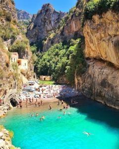 a group of people in the water at a beach at Casa Marta in Cava deʼ Tirreni