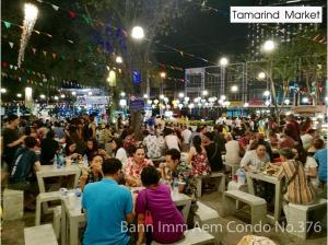 a large crowd of people sitting at tables at night at Bann Imm Aem Condo No.376 in Hua Hin