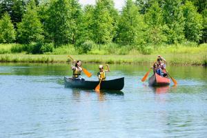 a group of people in kayaks on a river at Sahoro Resort Hotel in Shintoku