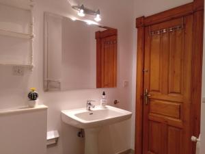 a bathroom with a sink and a mirror at Vivienda Vacacional El Robledo in Colombres +33 photos