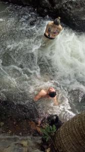 two people in the water in a river at Mi Casa - The gem of Ijen in Banyuwangi