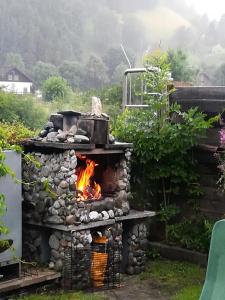 a stone oven with a fire in a yard at Ferienhaus Tüchler in Tamsweg